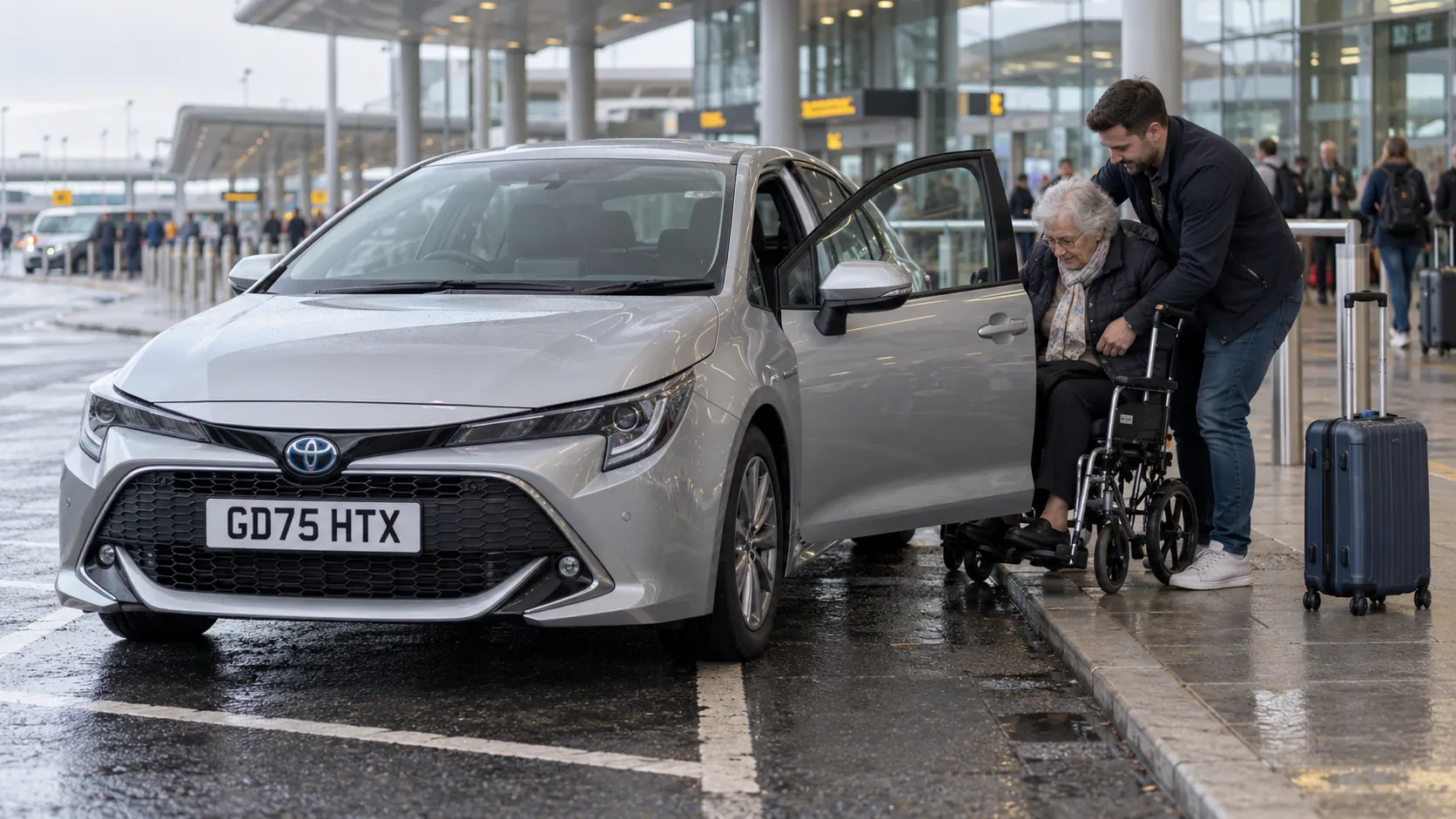 Son helping his mother from a silver car into her wheelchair at the Gatwick South Terminal drop-off zone